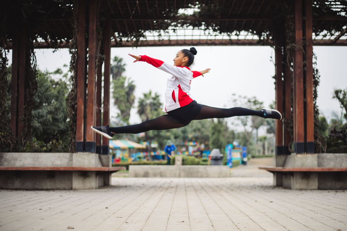 A young girl striking a gymnastic pose.